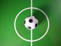 Toy soccerball in a midfield, in the center of the green field Royalty Free Stock Photo