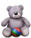 Toy soft teddy bear with striped ball Royalty Free Stock Photo