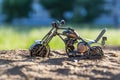 A toy sports bike stuck in sandy ground. Royalty Free Stock Photo