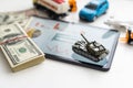 a toy tank, dollars and a tablet Royalty Free Stock Photo