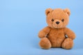 Toy teddy bear on blue background with copy space Royalty Free Stock Photo