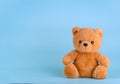 Toy teddy bear on blue background with copy space Royalty Free Stock Photo