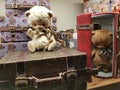 A toy teddy bear sits on a doll suitcase Royalty Free Stock Photo