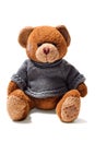 Toy teddy brown bear with patches in green sweater