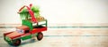 Toy tempo carrying christmas fir on wooden plank