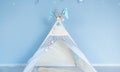 Toy tent in the children`s room on the background of the blue wall Royalty Free Stock Photo