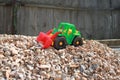 Toy tractor on a pile of rubble, kids game