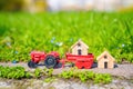 Toy Tractor and Small Wooden Houses in the Garden Royalty Free Stock Photo