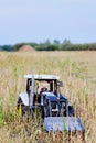 Toy tractor with toy tractor driver cow Royalty Free Stock Photo