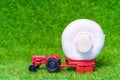 Toy tractor with a white button mushroom on green Royalty Free Stock Photo