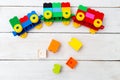 A toy train of cubes of lego on a wooden background. Educational Royalty Free Stock Photo