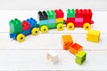 A toy train of cubes of lego on a wooden background. Educational Royalty Free Stock Photo
