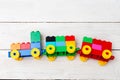 A toy train of cubes of lego on a wooden background. Educational Royalty Free Stock Photo