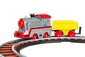 Toy train with freight car trolley on railway tracks, isolated on white background, children`s railway with steam locomotives, ba Royalty Free Stock Photo