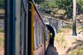 Toy Train moving on mountain slopes, beautiful view, one side mountain, one side valley moving on railway to the hill, among green Royalty Free Stock Photo