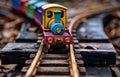 Toy train moving on the railroad. An old train track with a colorful wooden toy train on it Royalty Free Stock Photo