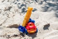 Toy truck with a boom in the wet sand. Summer holidays at sea. Special miniature.