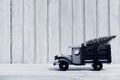 Toy truck carries gifts and a Christmas tree. Photo in vintage style Royalty Free Stock Photo