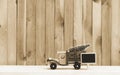 Toy truck carries gifts and a Christmas tree. Photo in vintage style Royalty Free Stock Photo