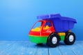 Toy truck dump truck on a blue background Royalty Free Stock Photo