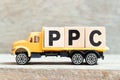 Toy truck hold letter block in word PPC Abbreviation of pay per click on wood background Royalty Free Stock Photo