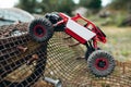 Toy truck overcoming grille with screws profile Royalty Free Stock Photo