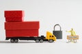 Toy truck with a trailer loaded with boxes of goods stands next to no traffic sign, padlock and customs officer. Concept of trade