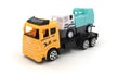 Toy truck with trailer transports telescopic lift on white background.