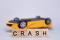 Toy upside down car and word Crash, accident concept, auto insurance Royalty Free Stock Photo