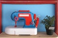 Toy and vintage sewing machine on blue background Royalty Free Stock Photo