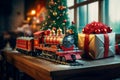 a toy vintage steam locomotive on a table under a decorated Christmas tree against the backdrop of a garland of bokeh lights Royalty Free Stock Photo