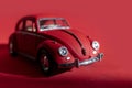 Toy Volkswagen Beetle on a red background, close-up, illustrative editorial. Date and location: Kiev, Ukraine September 2020 Royalty Free Stock Photo