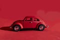 Toy Volkswagen Beetle on a red background, close-up, illustrative editorial. Date and location: Kiev, Ukraine September 2020 Royalty Free Stock Photo