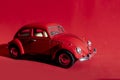 Toy Volkswagen Beetle on a red background, close-up, illustrative editorial. Date and location: Kiev, Ukraine September 2020 Royalty Free Stock Photo