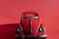 Toy Volkswagen Beetle on a red background, close-up, illustrative editorial Royalty Free Stock Photo