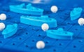 Toy war ships and submarine are placed on the blue playing Boar Royalty Free Stock Photo