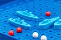 Toy war ships and submarine are placed on the blue playing Board Royalty Free Stock Photo