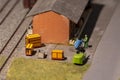 A toy warehouse with boxes and figures of people movers near the railway. Royalty Free Stock Photo