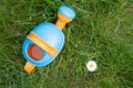 Toy watering can on the background of daisies Royalty Free Stock Photo