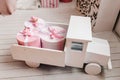 Toy white wooden car with gifts. Elegant pink boxes in back of truck. Birthday present. Copy space, holiday concept. Discounts, Royalty Free Stock Photo