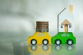 Toy wooden car carry wooden house and money on top Royalty Free Stock Photo