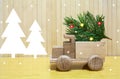 Toy wooden car and christmas tree Royalty Free Stock Photo