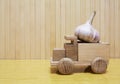 Toy wooden car with garlic Royalty Free Stock Photo