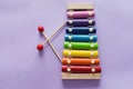 A toy wooden colorful xylophone on purple background with copy space. Children`s toy and musical instrument. Music and childhood Royalty Free Stock Photo