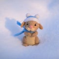 Toy woolly rabbit in a winter hat and scarf