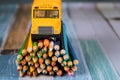 Toy yellow bus on bunch of colored pencils Royalty Free Stock Photo