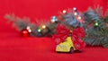 Toy yellow small car with red bow on red background with blurred bokeh and Christmas tree branch Royalty Free Stock Photo