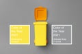 Toy yellow waste bin on gray background