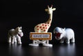 Toy zebra, hippo and giraffe next to Save us sign. Concept for the protection of nature and the preservation of rare exotic