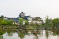 Toyama castle with beautiful garden and reflection in water.